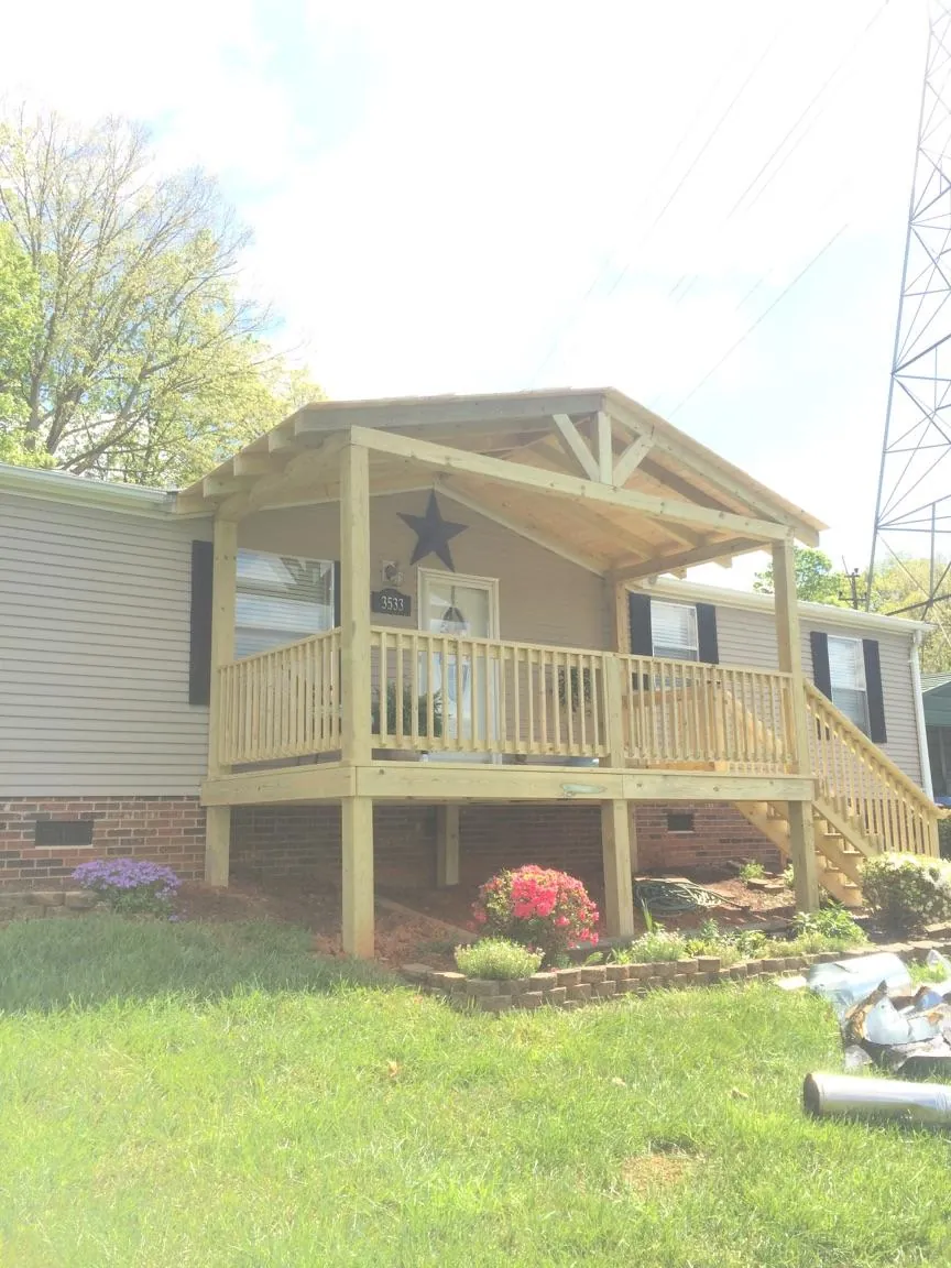 New gabled porch roof and deck railing added to a ranch home in Monroeville